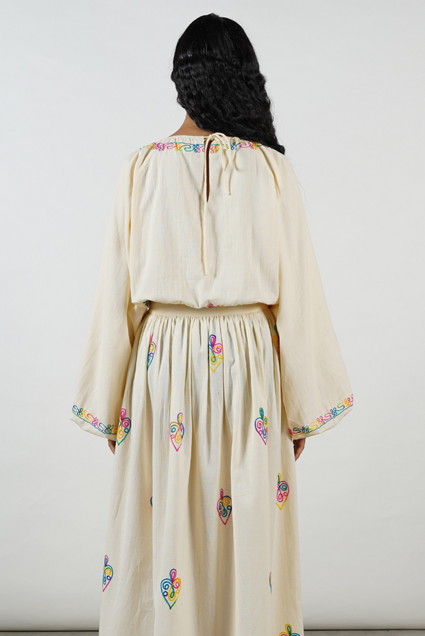 Sustainable brand, Hand-embroidered, vibrant motifs, Ecru cotton, voluminous sleeves, nostalgic design