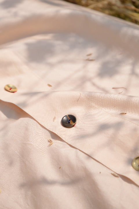 Close up of hand made buttons on the feminist shirt dress in cotton silk
